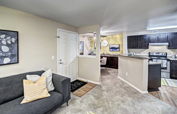 Spacious living room with modern furnishings at Bay Court at Harbour Pointe Apartments