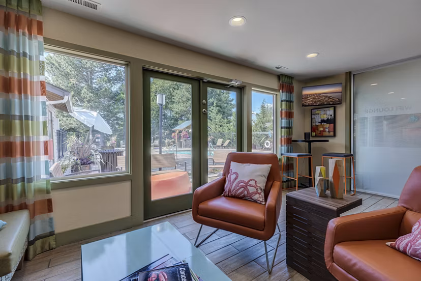 Clubhouse at The Berkshire Apartments featuring a modern lounge area with stylish seating and games for resident enjoyment