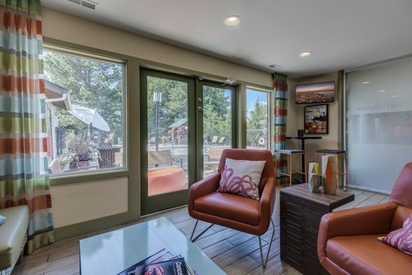 Clubhouse at The Berkshire Apartments featuring a modern lounge area with stylish seating and games for resident enjoyment