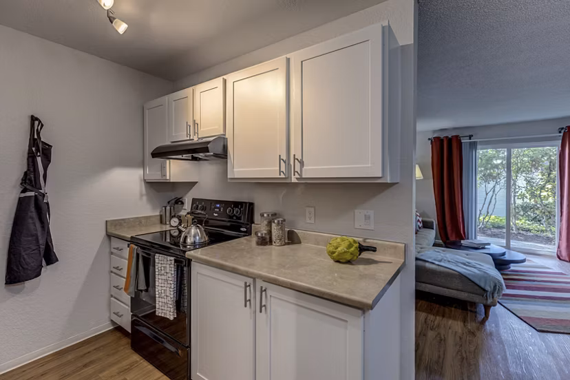 Kitchen featuring modern appliances and island counter at The Berkshire Apartments