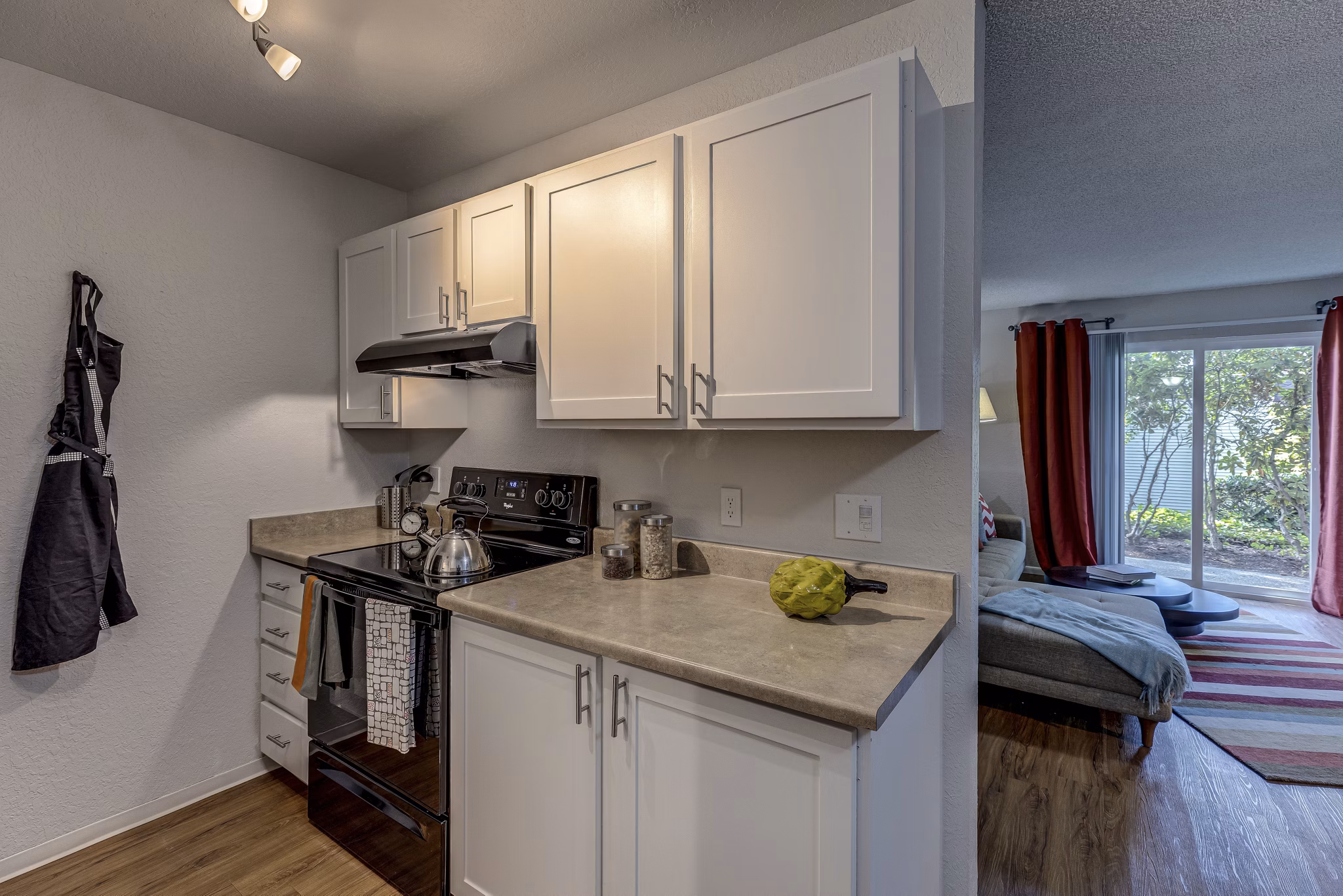 Kitchen featuring modern appliances and island counter at The Berkshire Apartments