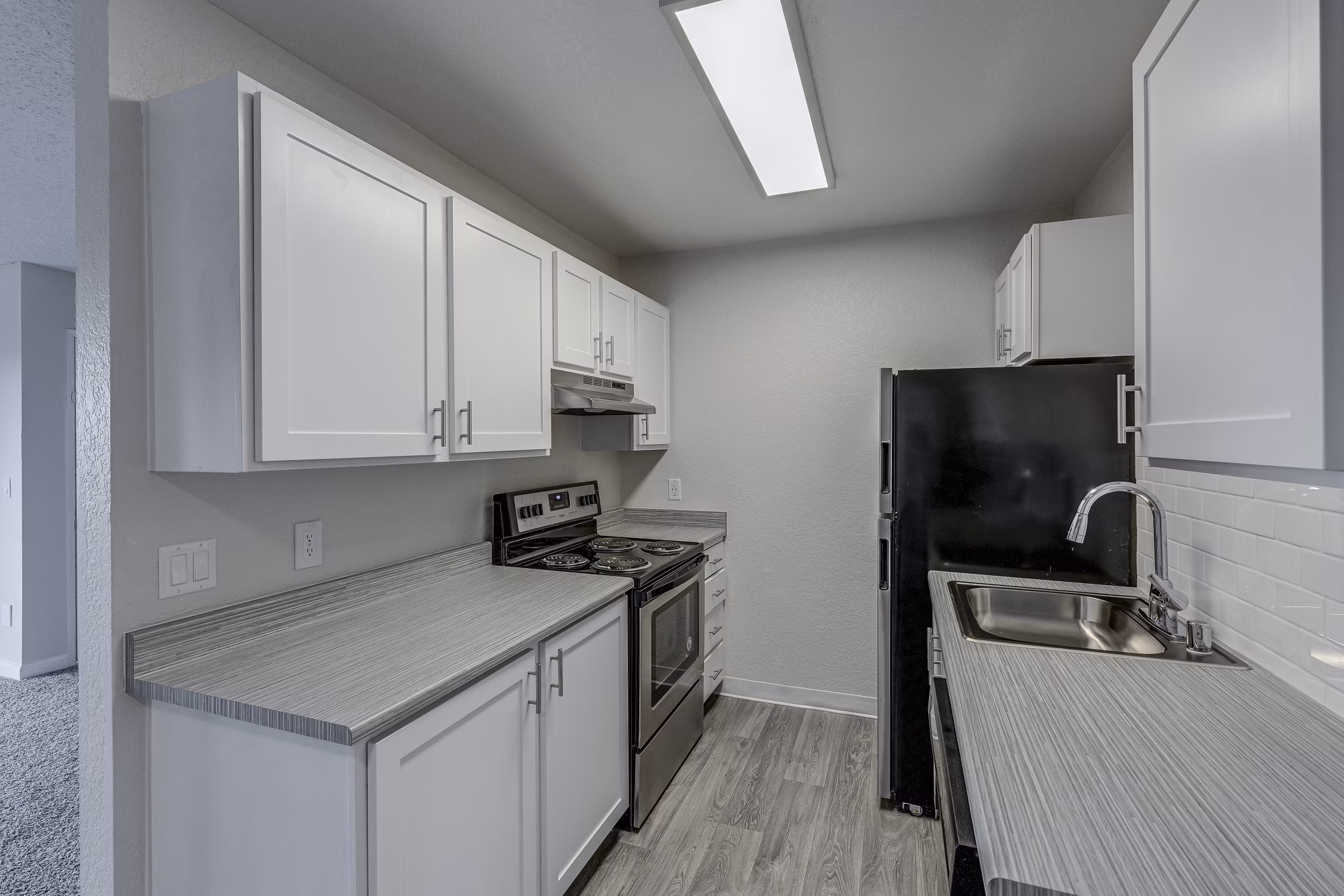 Modern kitchen with stainless steel appliances at The Berkshire Apartments