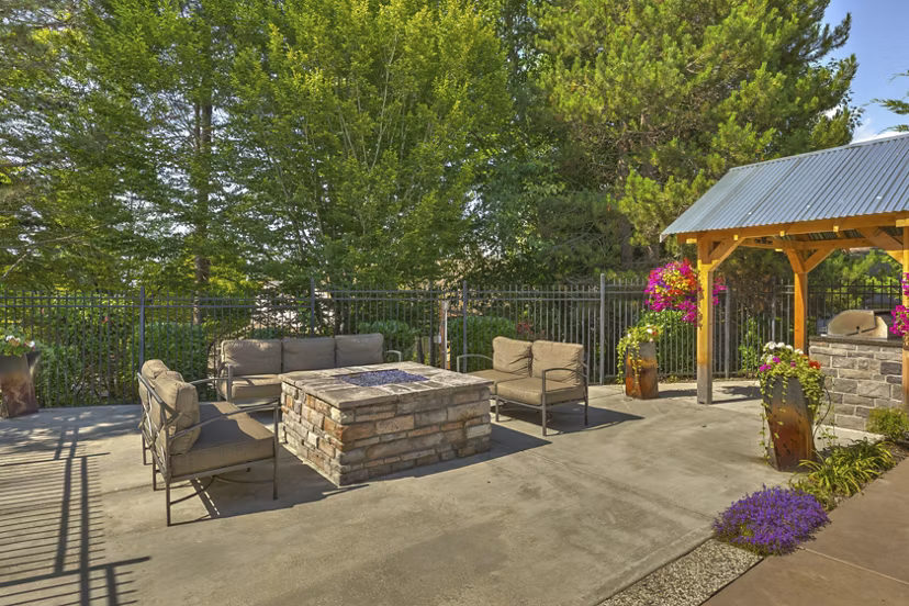 Cozy fire pit at The Berkshire Apartments with seating for social gatherings