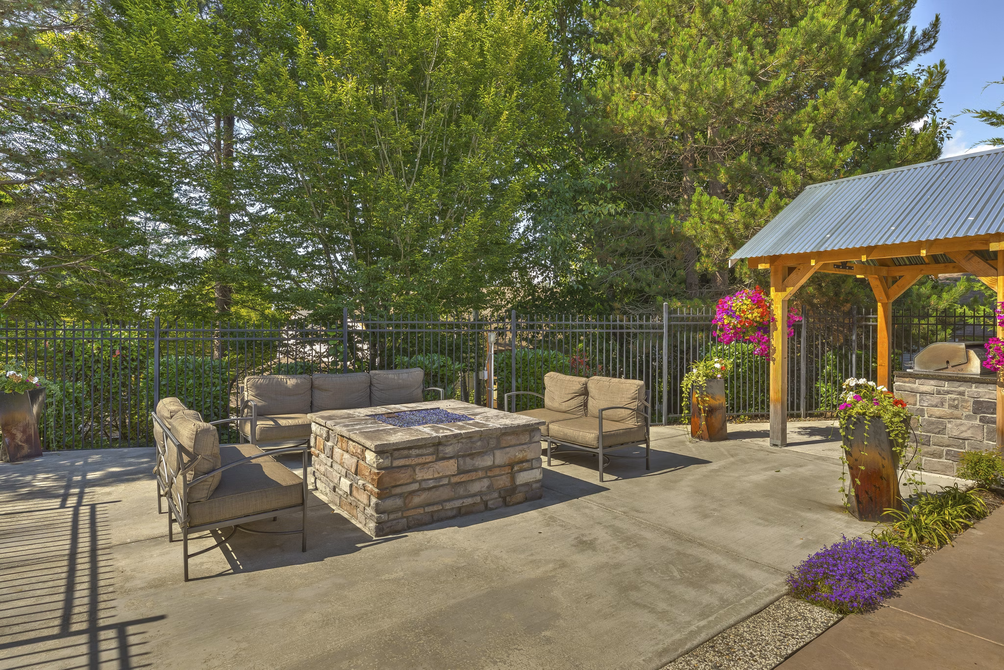 Cozy fire pit at The Berkshire Apartments with seating for social gatherings