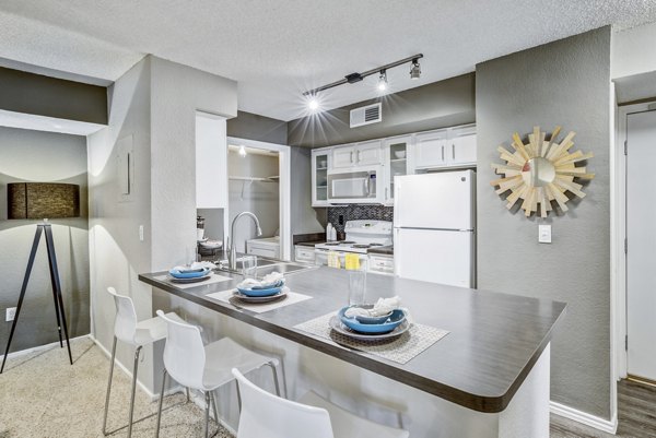 Modern kitchen with stainless steel appliances at Stratford Station Apartments