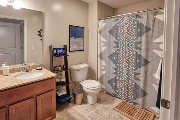 Modern bathroom with sleek fixtures and ample lighting in Campus Pointe Apartments, a luxury housing community by Greystar
