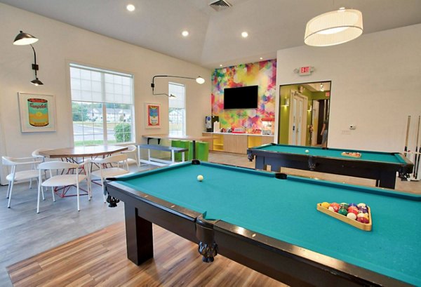 Clubhouse with lounge seating and billiards table at Campus Pointe Apartments