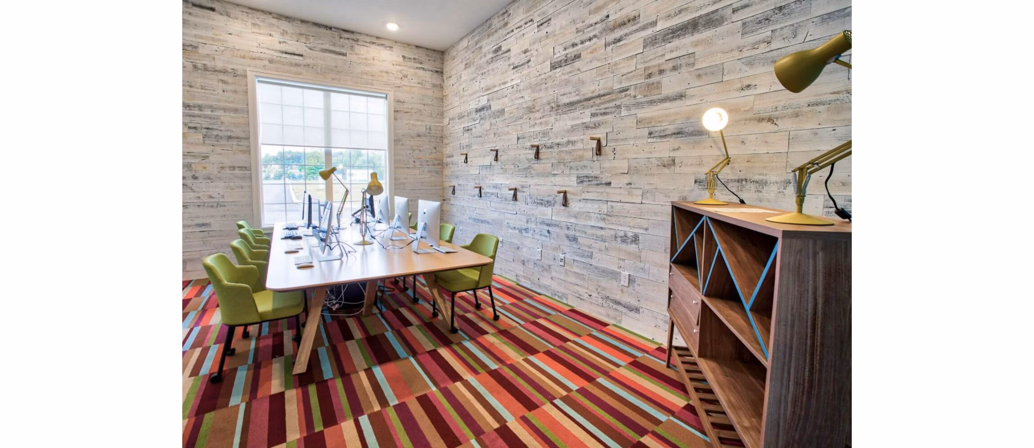 Modern clubhouse with lounge seating and games at Campus Pointe Apartments, perfect for social gatherings and community events