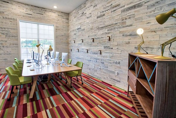 Modern clubhouse with lounge seating and games at Campus Pointe Apartments, perfect for social gatherings and community events