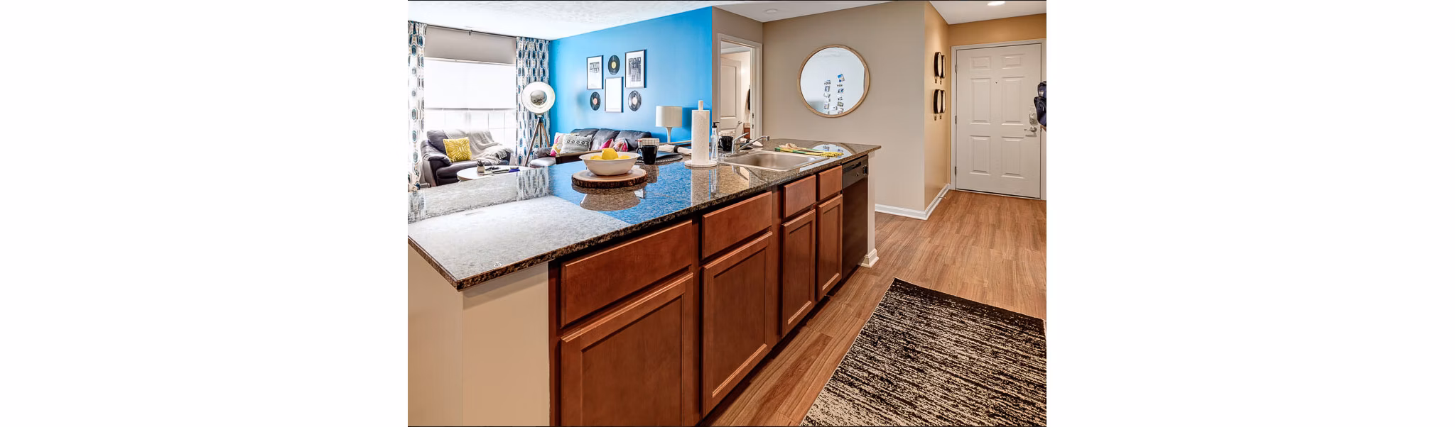 Modern kitchen featuring stainless steel appliances and granite countertops at Campus Pointe Apartments