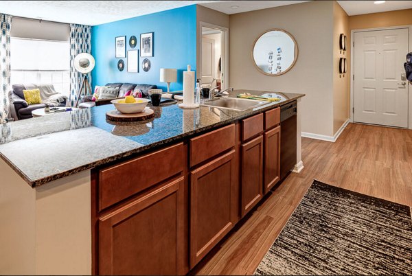 Modern kitchen featuring stainless steel appliances and granite countertops at Campus Pointe Apartments