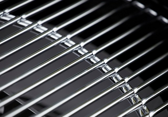 Close-up of a clean, stainless steel wire cooking grid, with a focused perspective creating a blurred background.
