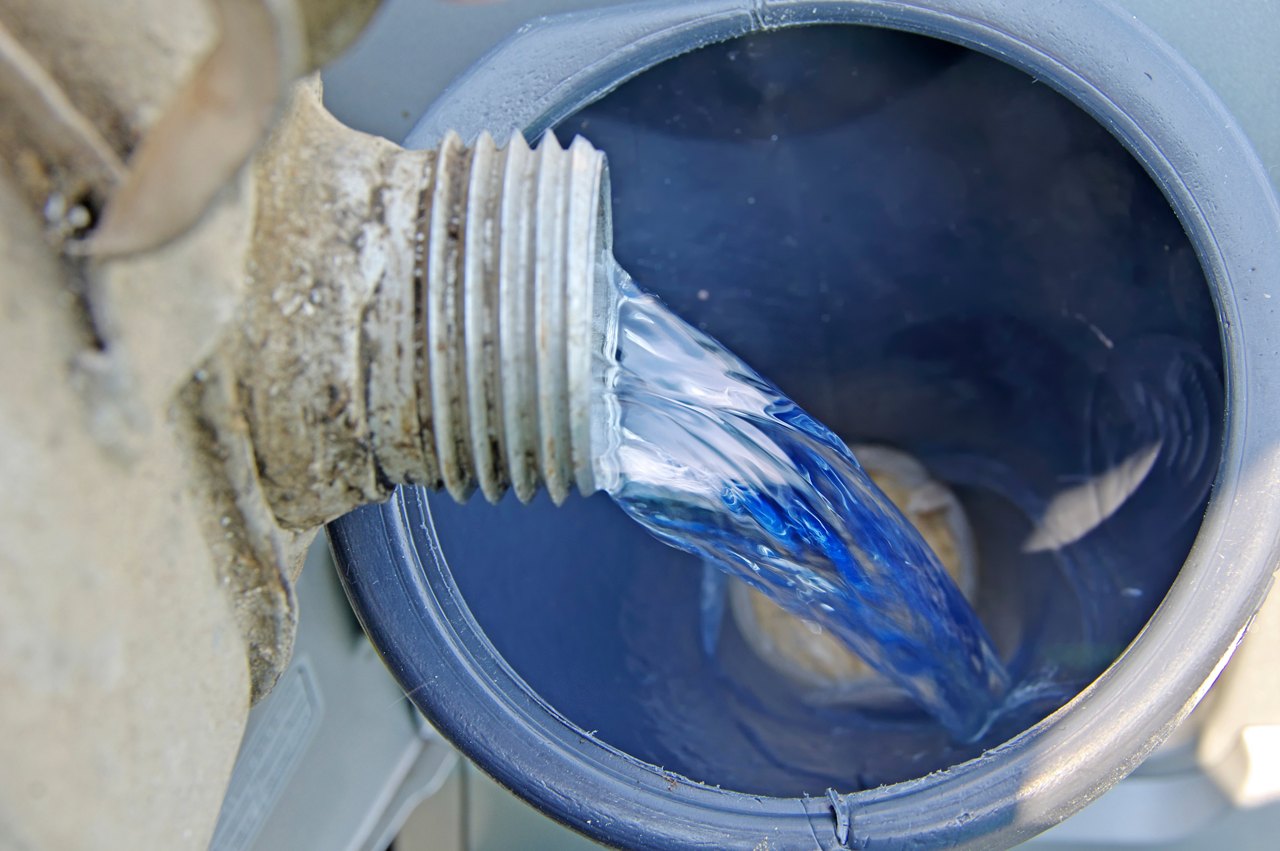 Pouring gasoline   through funnel in  tank car