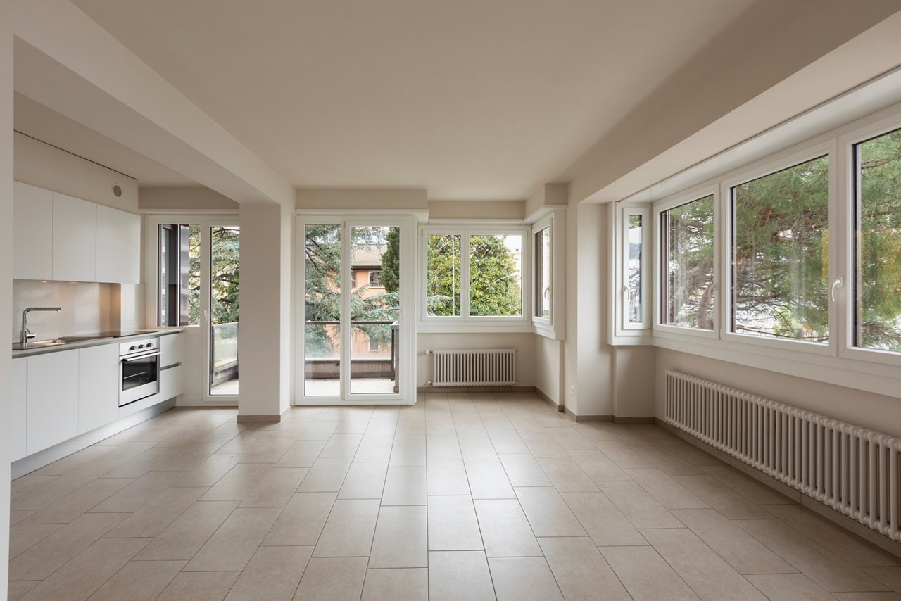 Open space with large windows and modern kitchen. Nobody inside