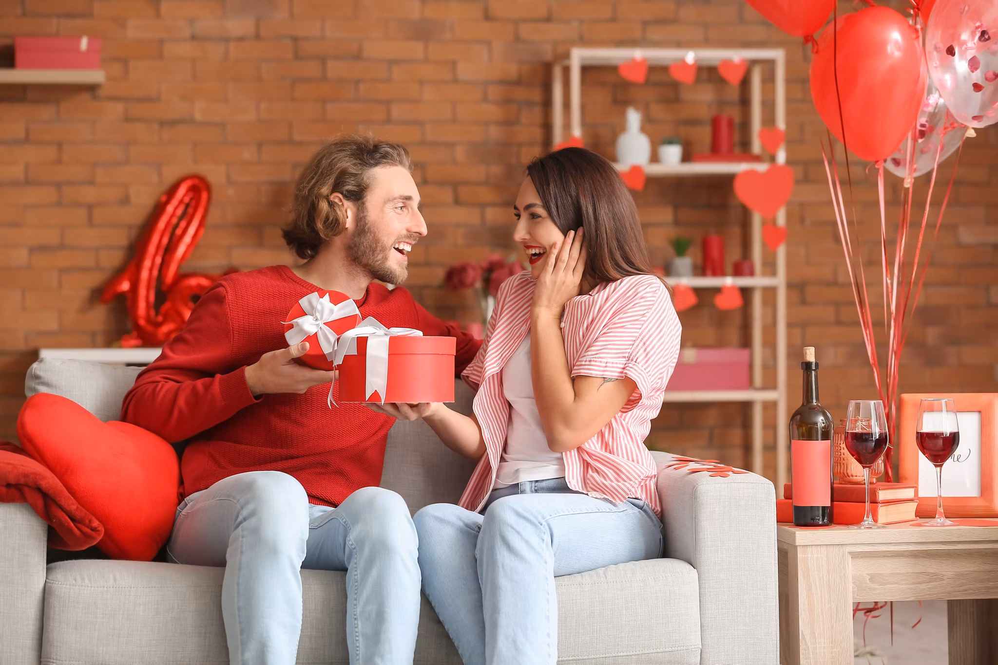 Happy couple greeting each other on Valentine's Day at home