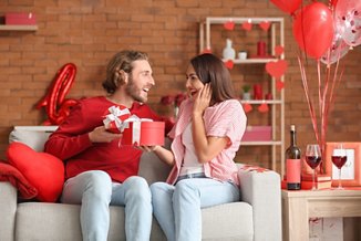 Happy couple greeting each other on Valentine's Day at home