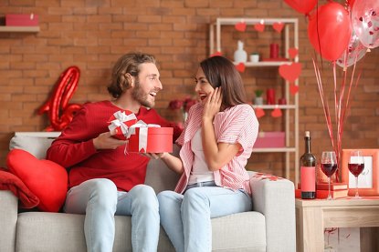 Happy couple greeting each other on Valentine's Day at home