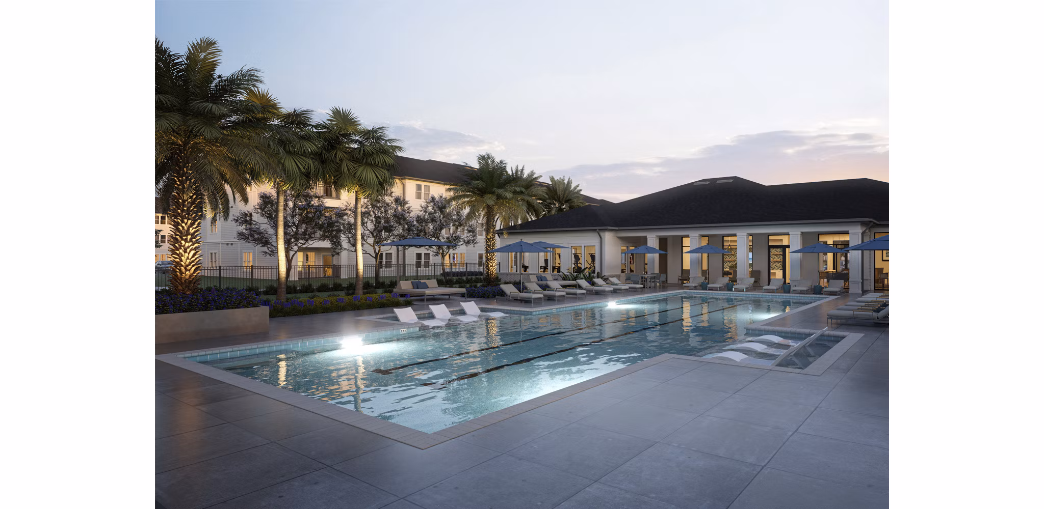 Twilight view of a serene residential pool area surrounded by palm trees, with lounge chairs and umbrellas, reflecting the calm evening sky.