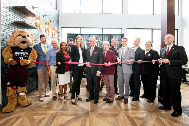 Team Ribbon Cutting a New Location with a Bulldog Mascot