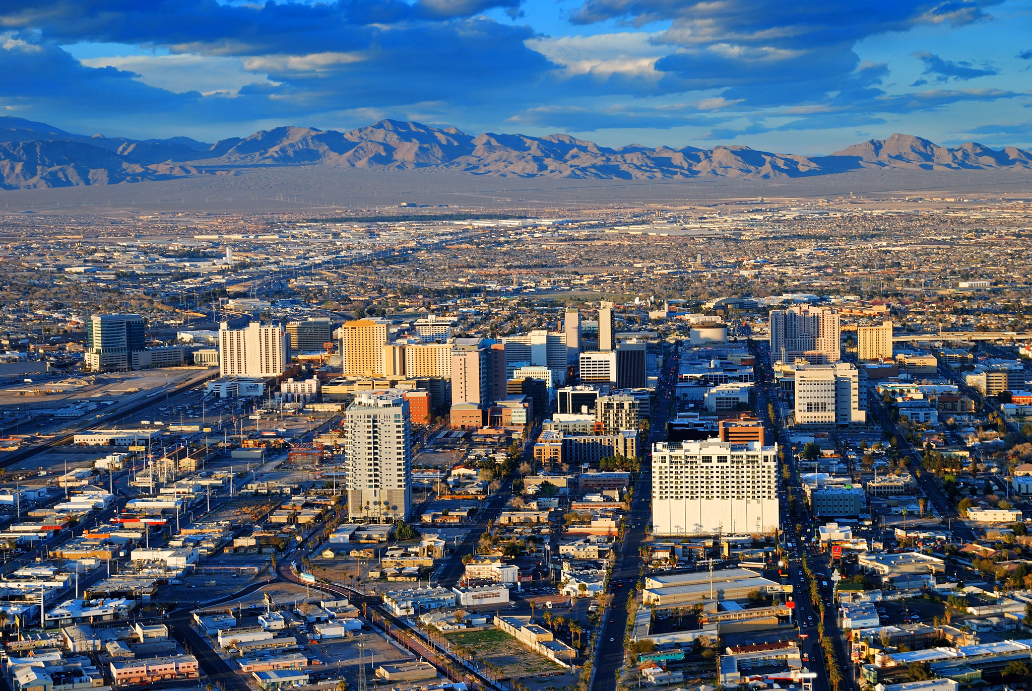 Las Vegas street Skyline aerial view with mountain and hotels on strip.