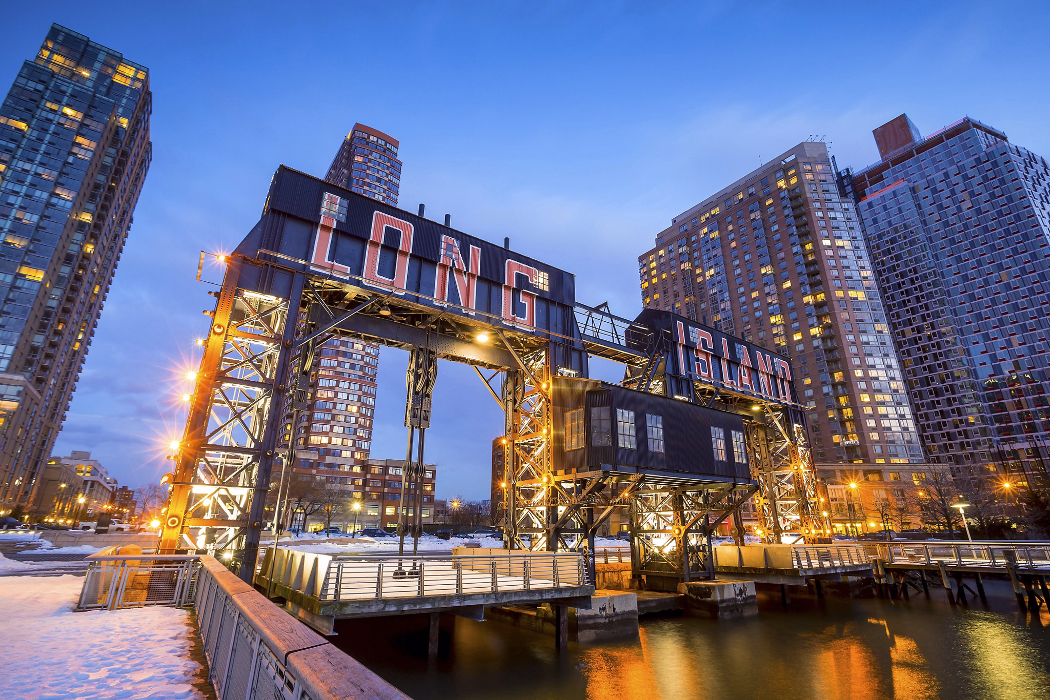 the buildings of long island in front of east river at twilight