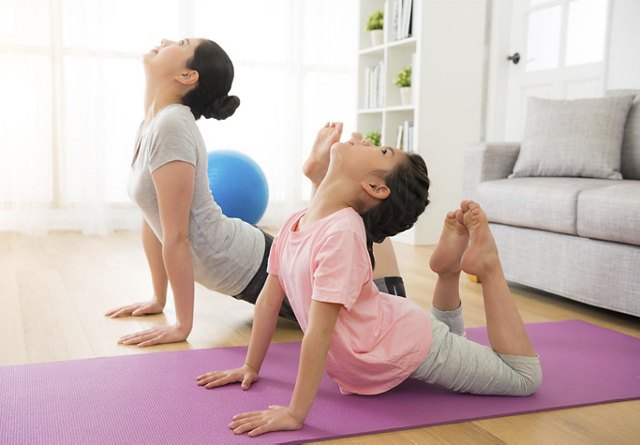 Mother and Daughter do Yoga
