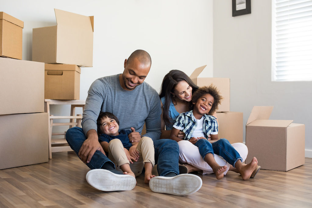 Family sitting around moving boxes