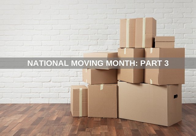 Piled cardboard boxes against a white brick wall on a wooden floor, with the text 'National Moving Month: Part 3'.