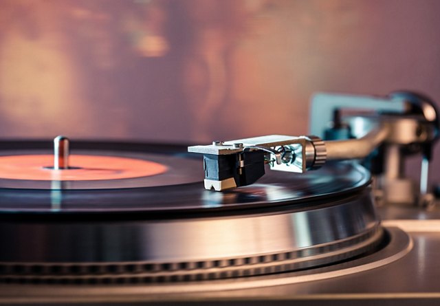 Close-up view of a vinyl record playing on a turntable with a stylus needle.