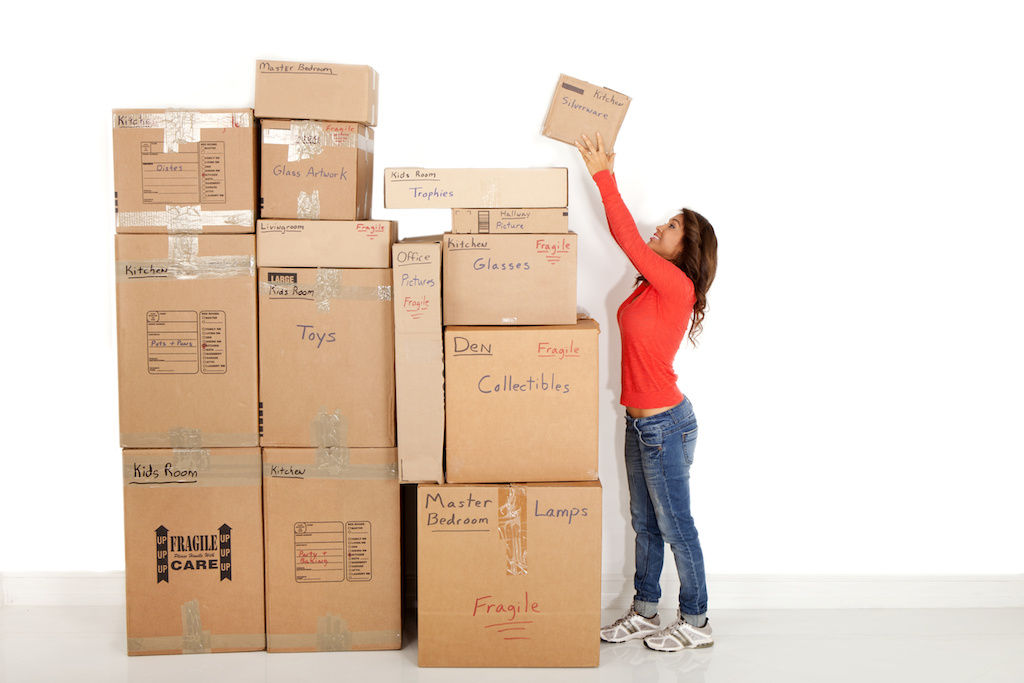 Woman packing boxes to move to apartment