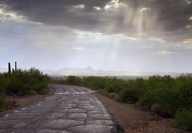 Beautiful rays of light, God rays, coming through rain clouds after an afternoon, monsoon storm in Tucson, Arizona.
