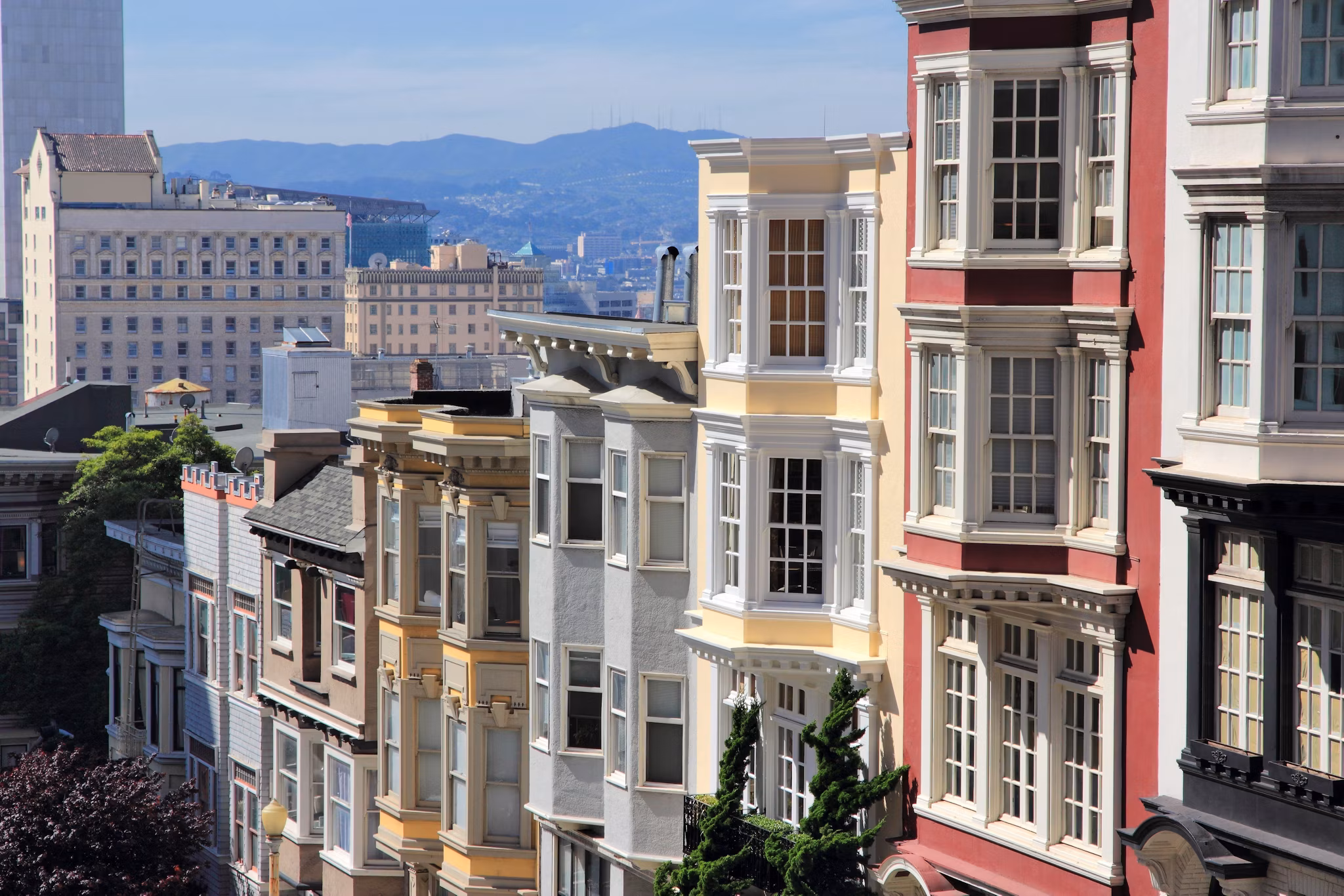 Iconic buildings on the slopes of Nob Hill, California, overlooking city skyline.