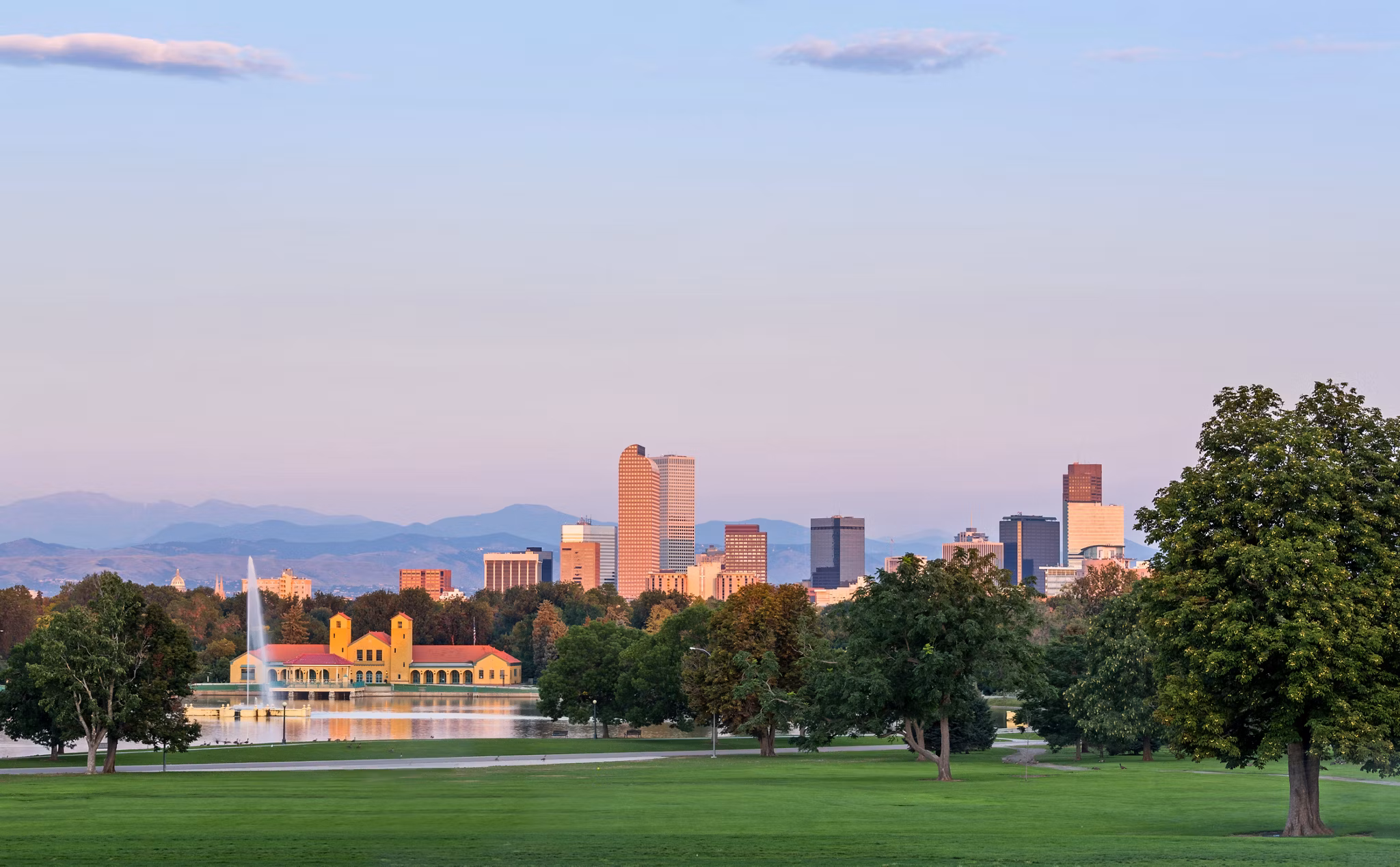 City skyline of Denver Colorado from the City Park taken from front of Science Museum just before sunrise with the fountain and Boathouse and Ferril Lake