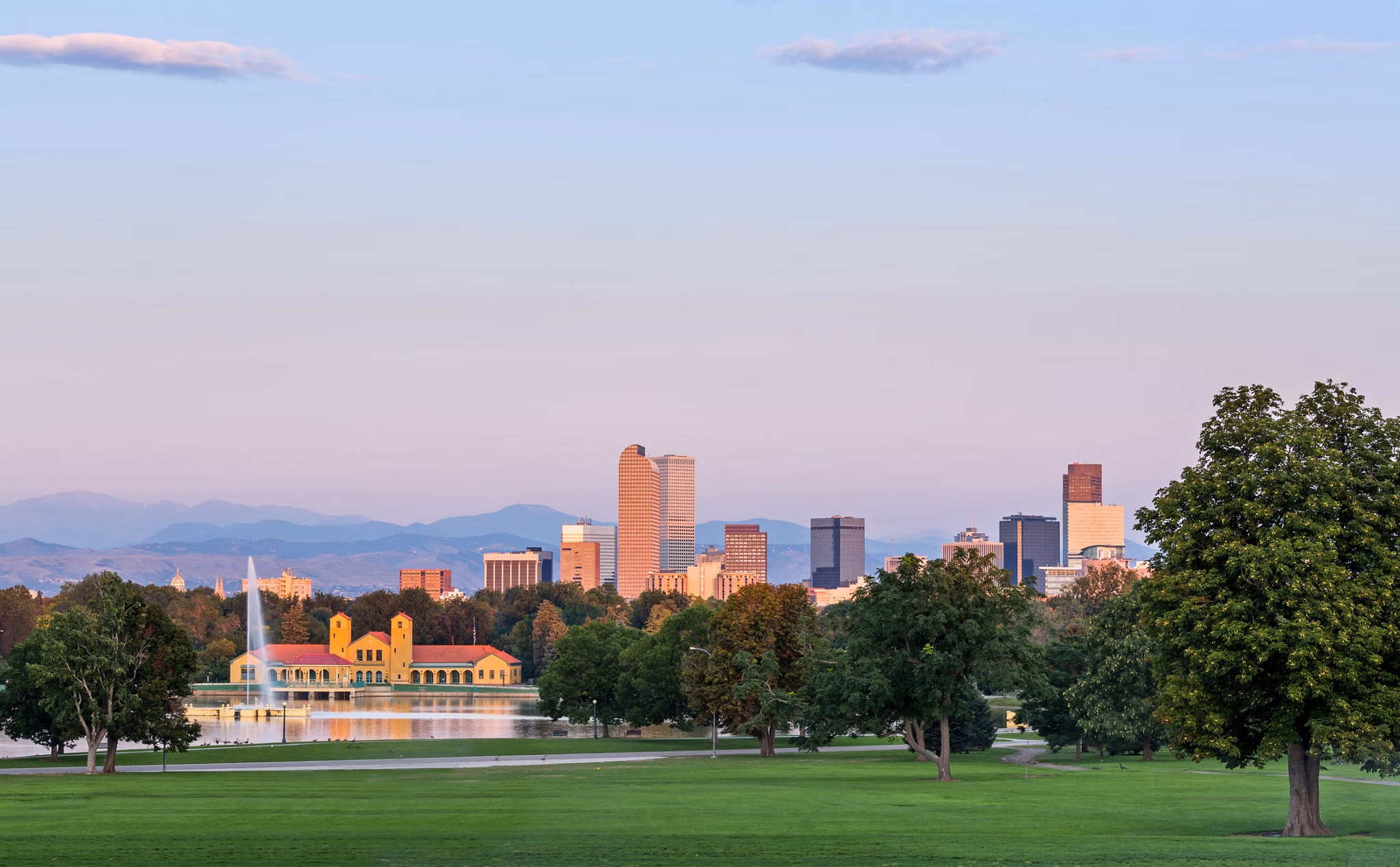 City skyline of Denver Colorado from the City Park taken from front of Science Museum just before sunrise with the fountain and Boathouse and Ferril Lake