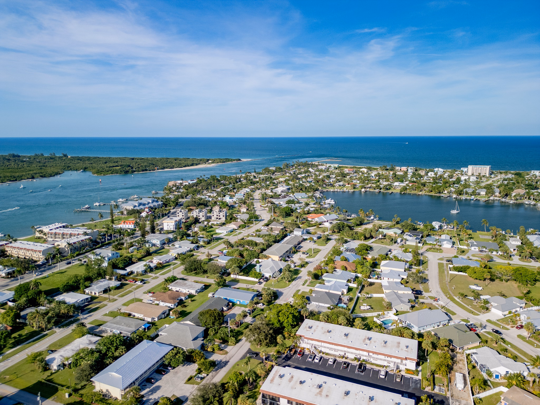 Aerial view of Port St. Lucie, Florida, showing residential neighborhoods between waterways, with the Atlantic Ocean in the background.