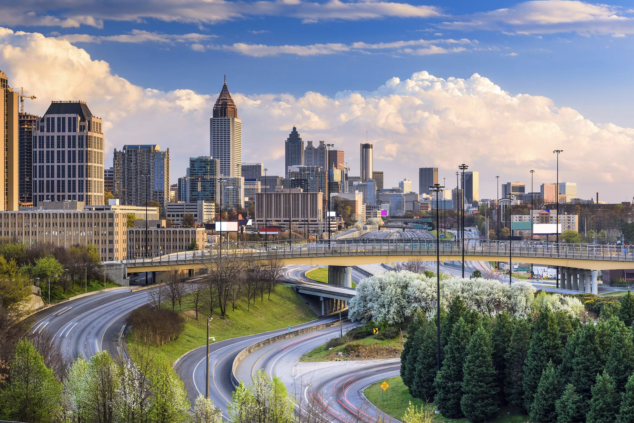 Lindridge-Martin Manor/Lindbergh, GA with highways, blooming trees, and Atlanta skyline featuring Bank of America tower.