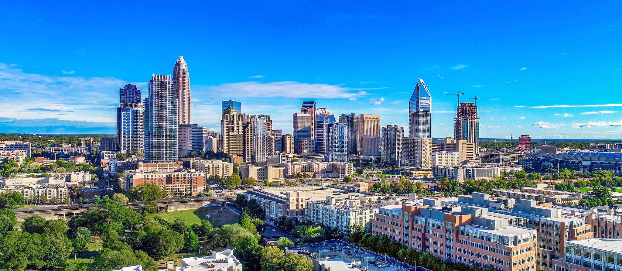 Panoramic view of Charlotte NC skyline showing uptown apartments and residential communities - North Carolina urban living