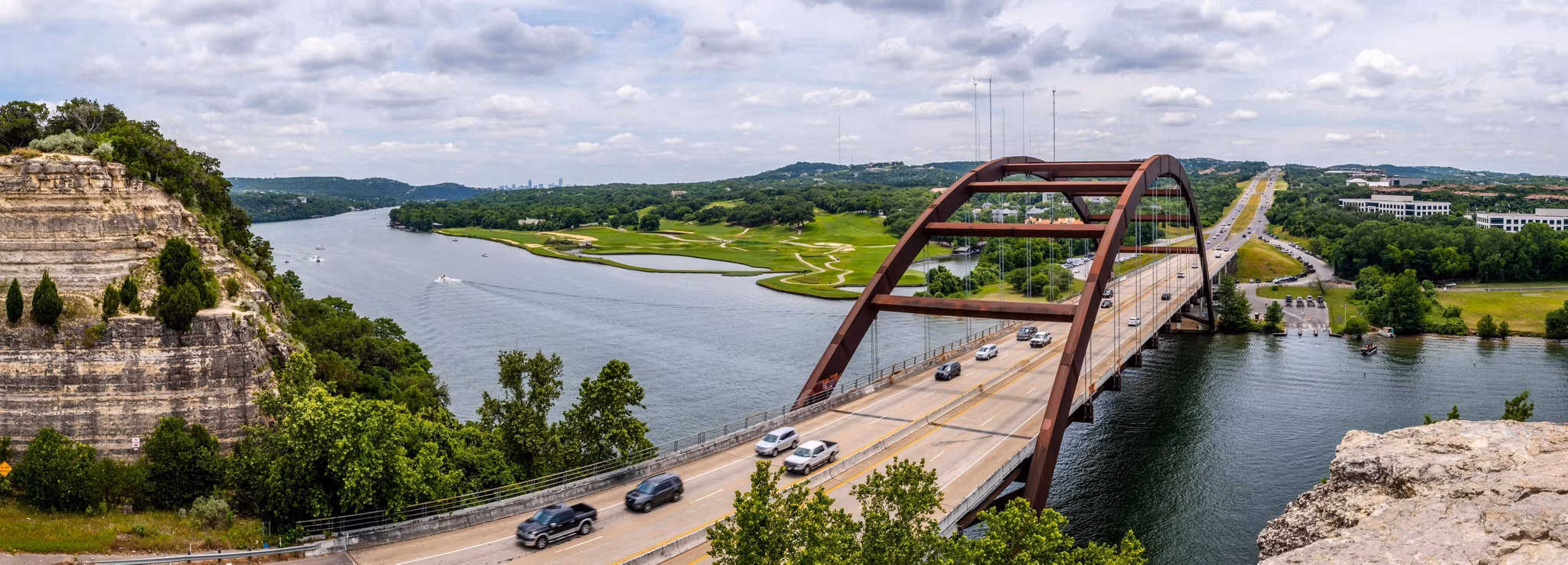 An ariel view of cars crossing over a bridge in West Austin, Texas