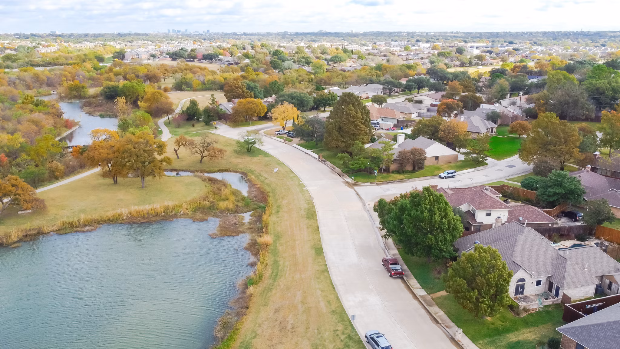 Aerial view of the Carrollton/Hebron neighborhood in Texas, featuring homes and lush greenery spread across a hilly landscape.