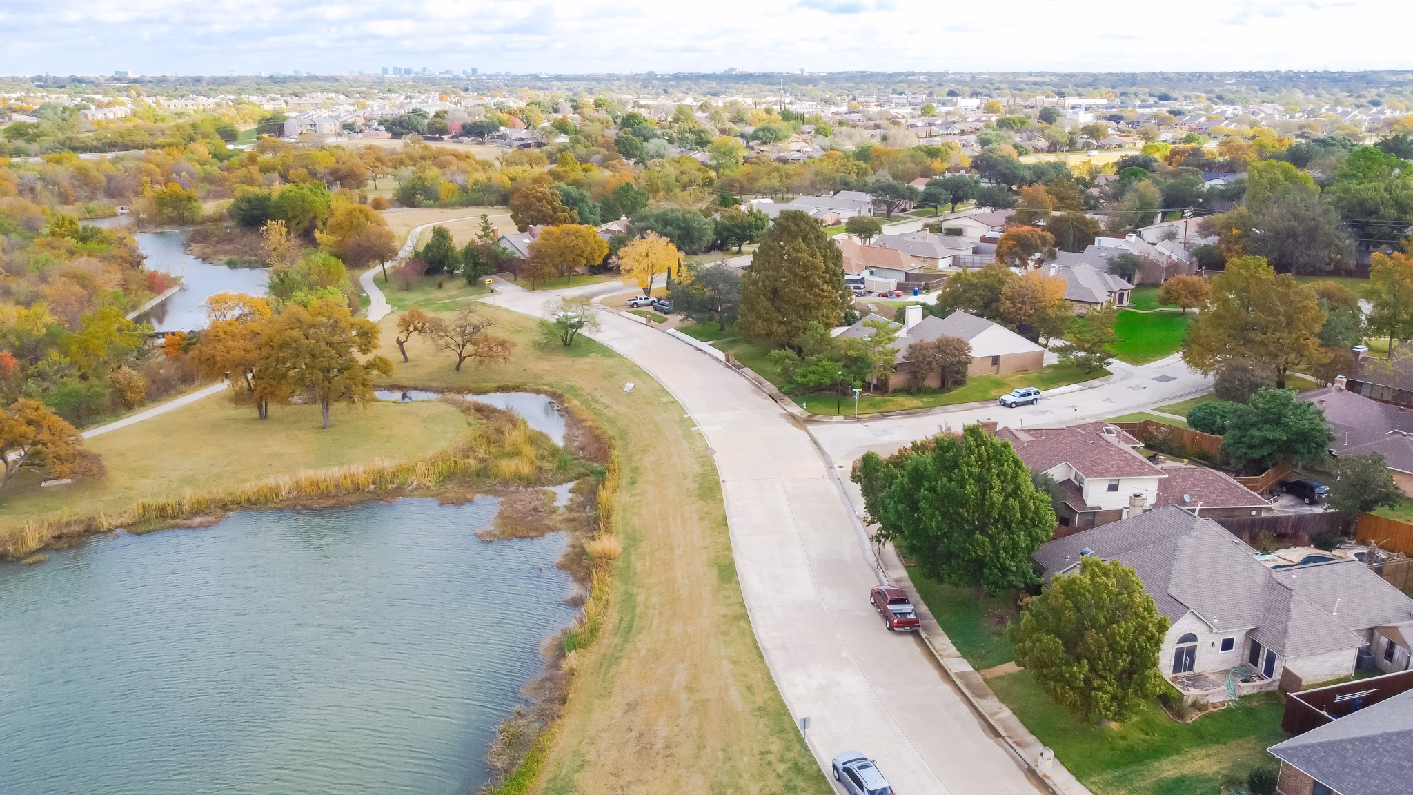 Aerial view of the Carrollton/Hebron neighborhood in Texas, featuring homes and lush greenery spread across a hilly landscape.