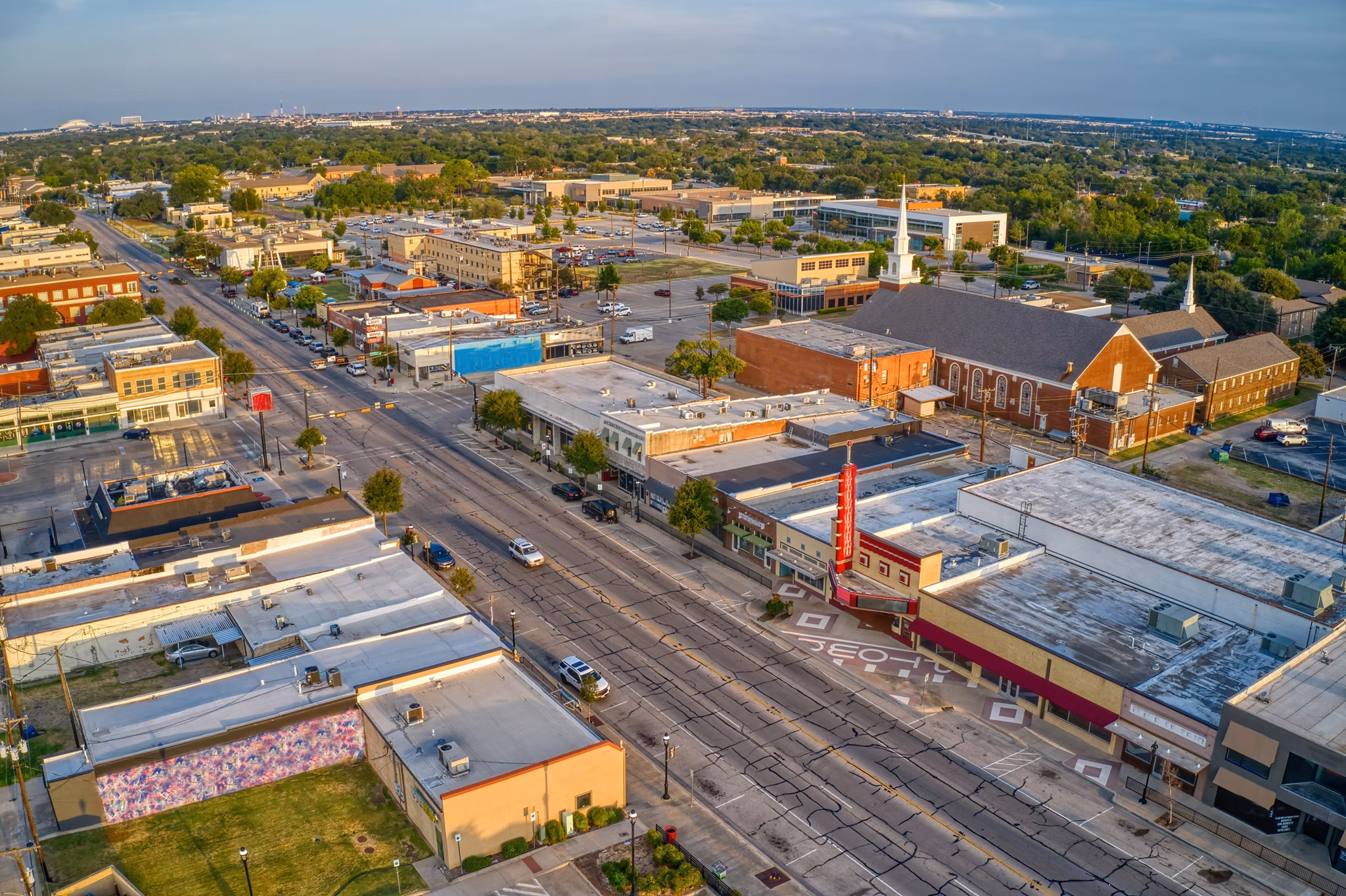 Aerial view of Grand Prairie, Texas, showing shops, streets, and buildings in a lively neighborhood.