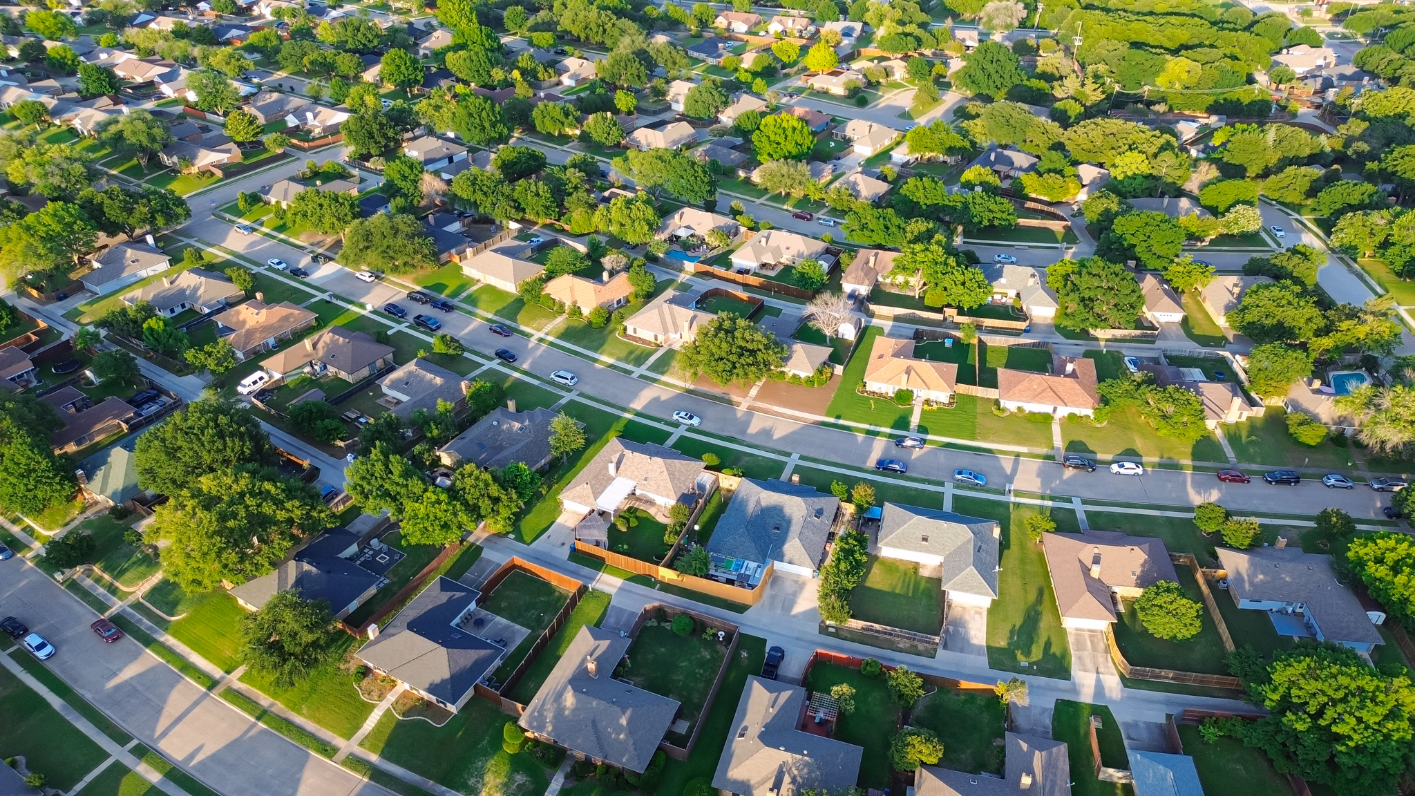 Aerial view of Mansfield, Texas, showing a residential neighborhood with many houses and green trees.