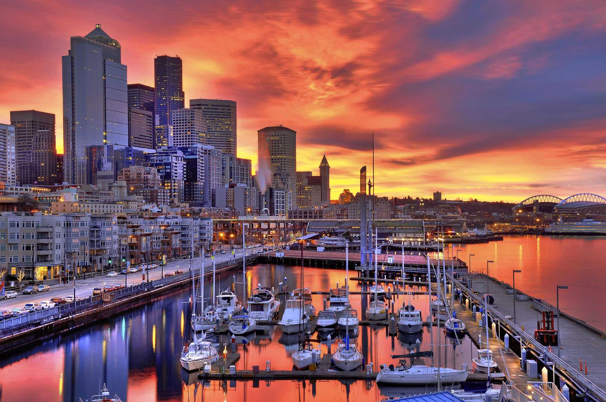 High dynamic image of Seattle skyline in dramatic sunrise colors across pier-66 waterfront