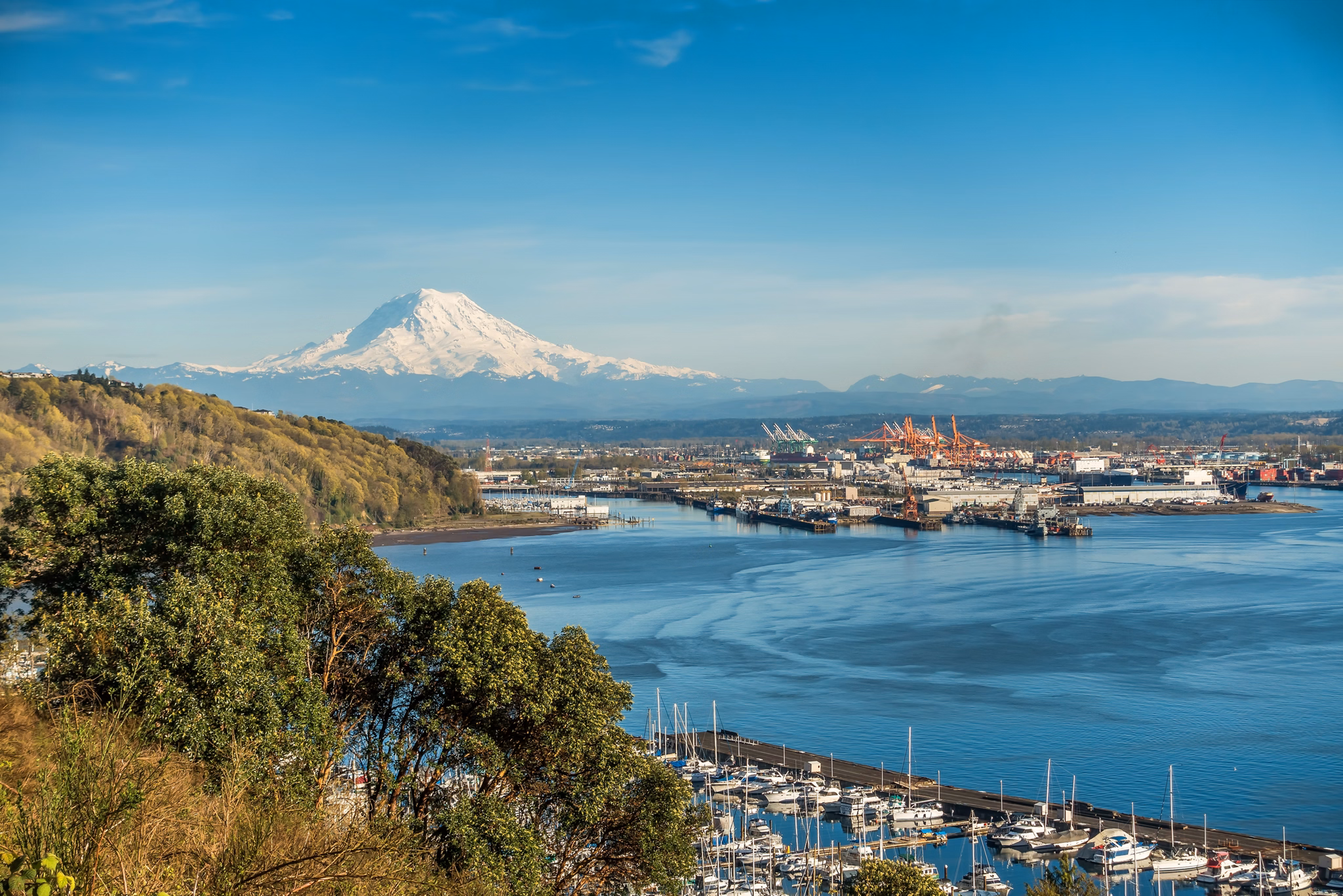 A panoramic view of Mount Rainier, The Port of Tacoma and a marina.