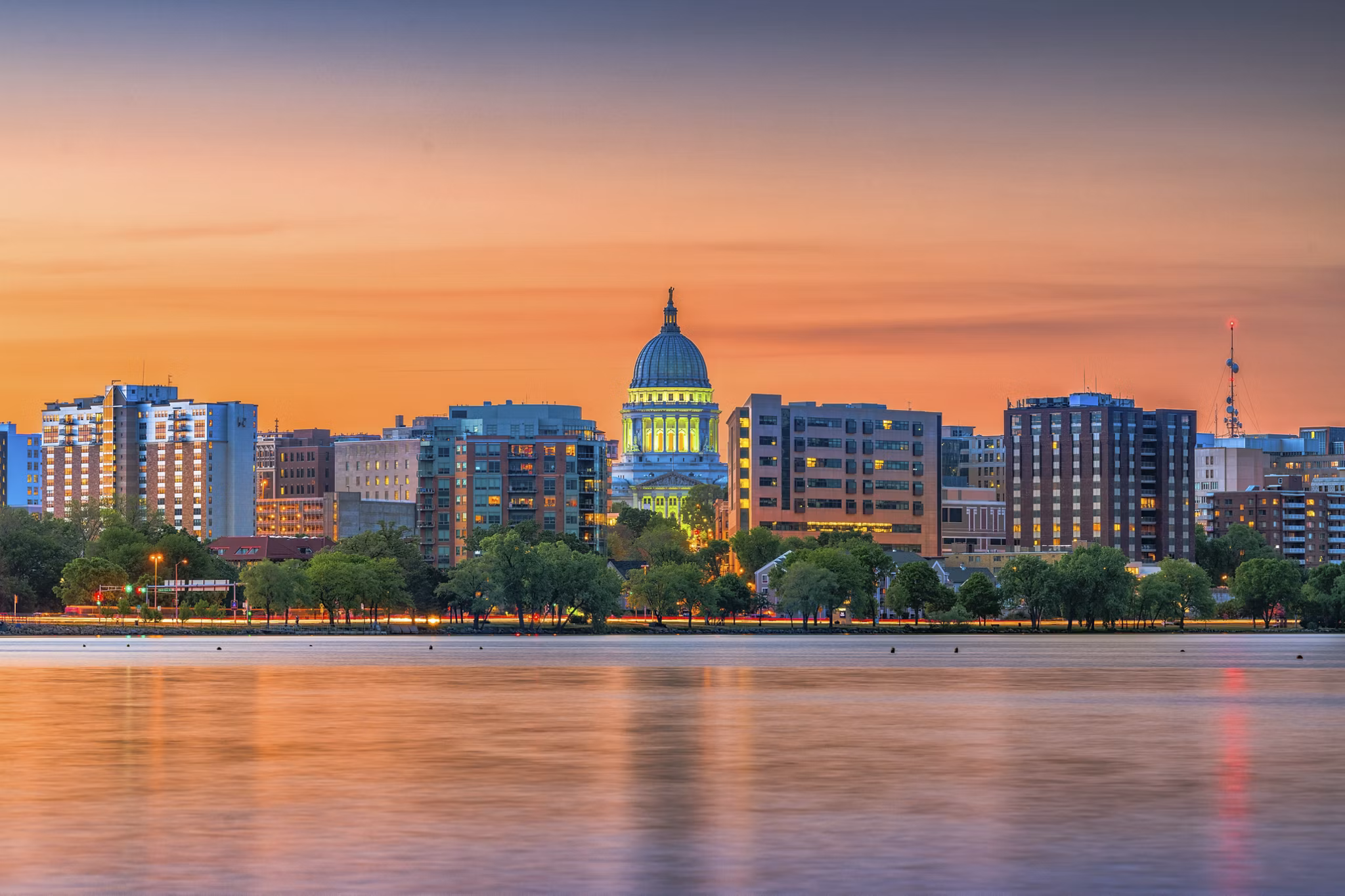 Madison, Wisconsin, USA downtown skyline at dusk on Lake Monona.