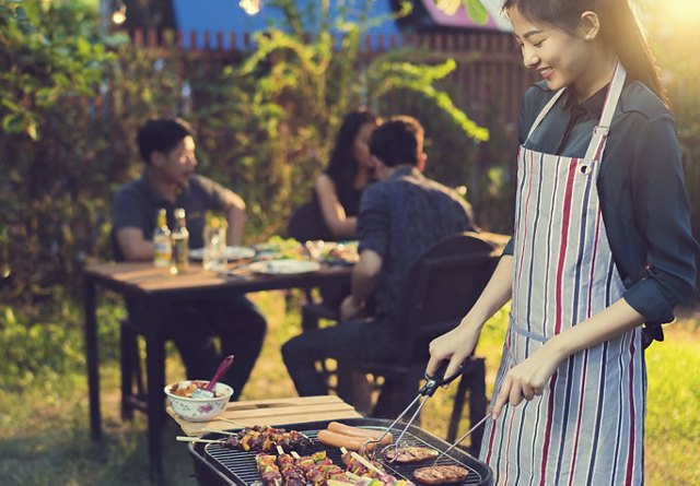 Woman BBQs for Friends | Greystar
