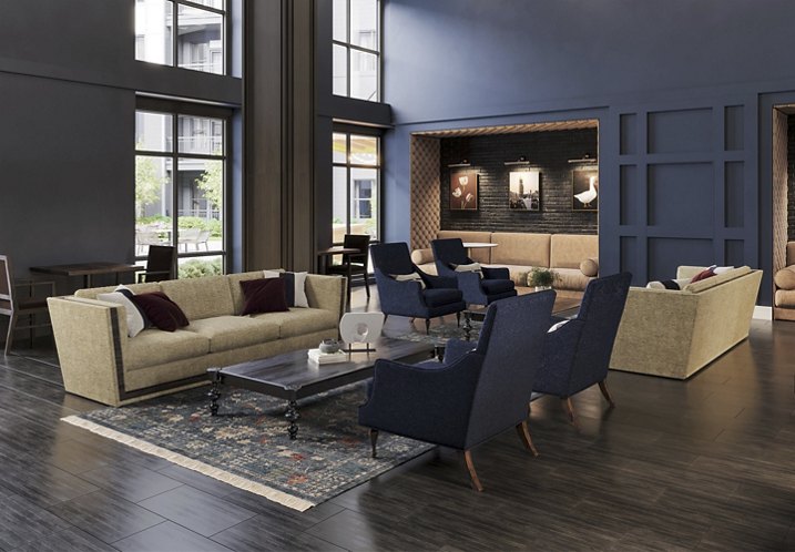 A modern lounge with beige sofas, blue armchairs, a dark wood coffee table, and decorative lighting.