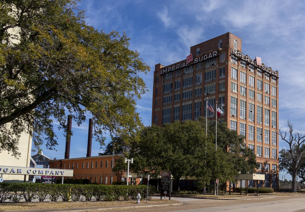 Sunny day in Sugar Land, Texas, showcasing the tall Imperial Sugar Factory building.