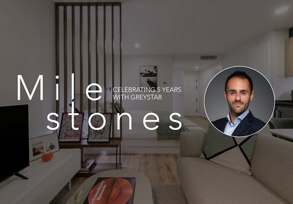 Blog banner image featuring the word 'Milestones,' a headshot of Georgios Karachalios, and a background of a modern apartment setting.