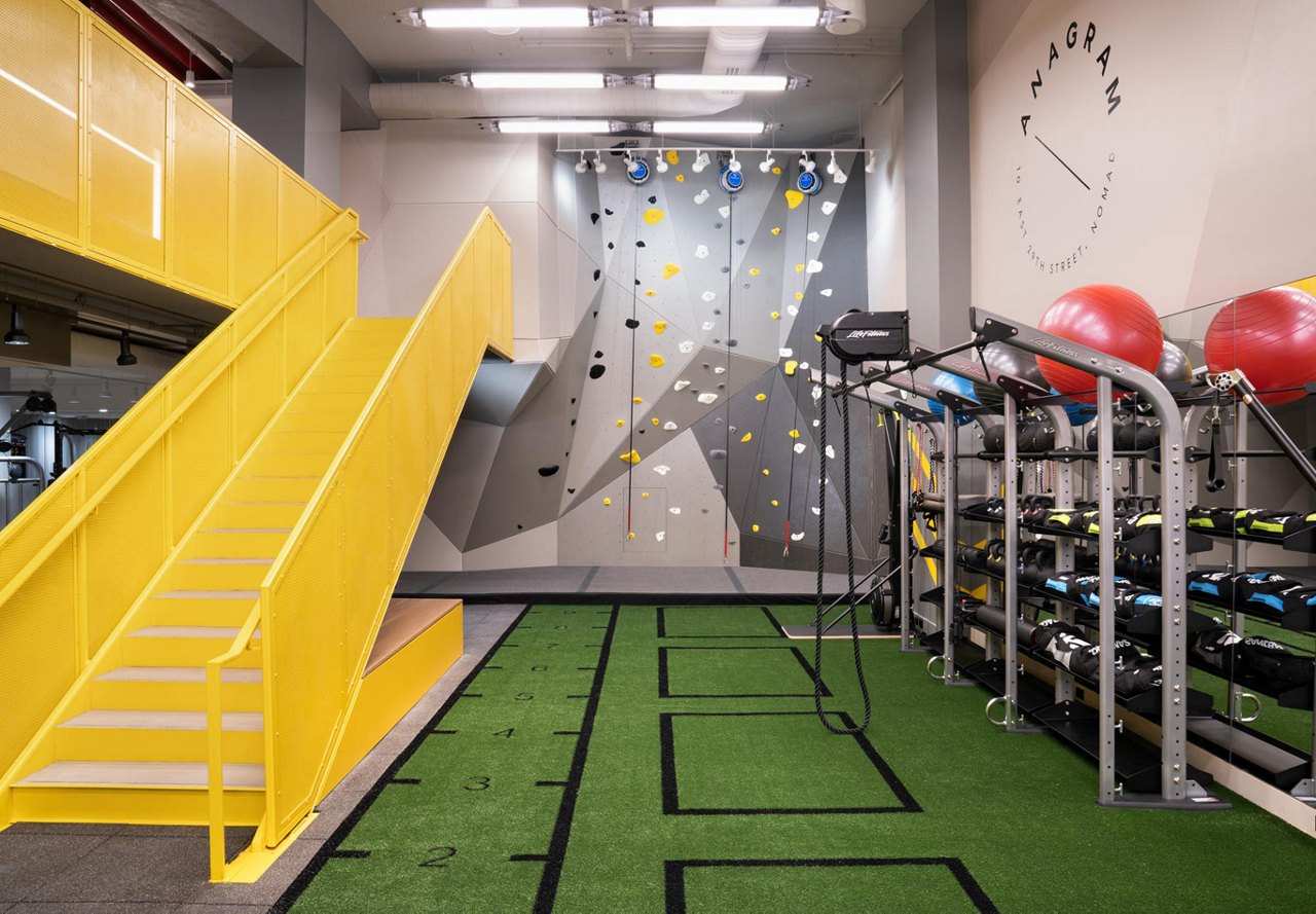 Fitness center at apartment with rock climbing wall in the city of New York